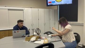 Student at laptop in classroom learning Physics.